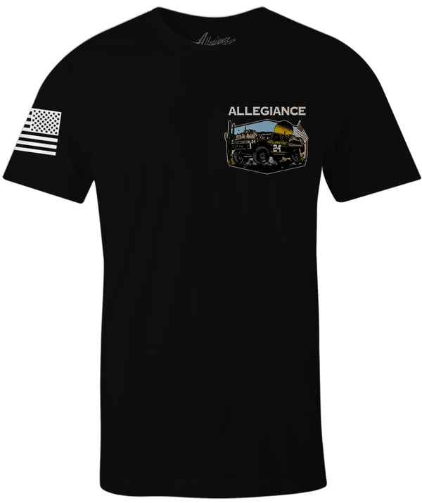 Front of Baja Classic Tee in black featuring small off-road racing truck chest graphic with American flag and Allegiance branding.